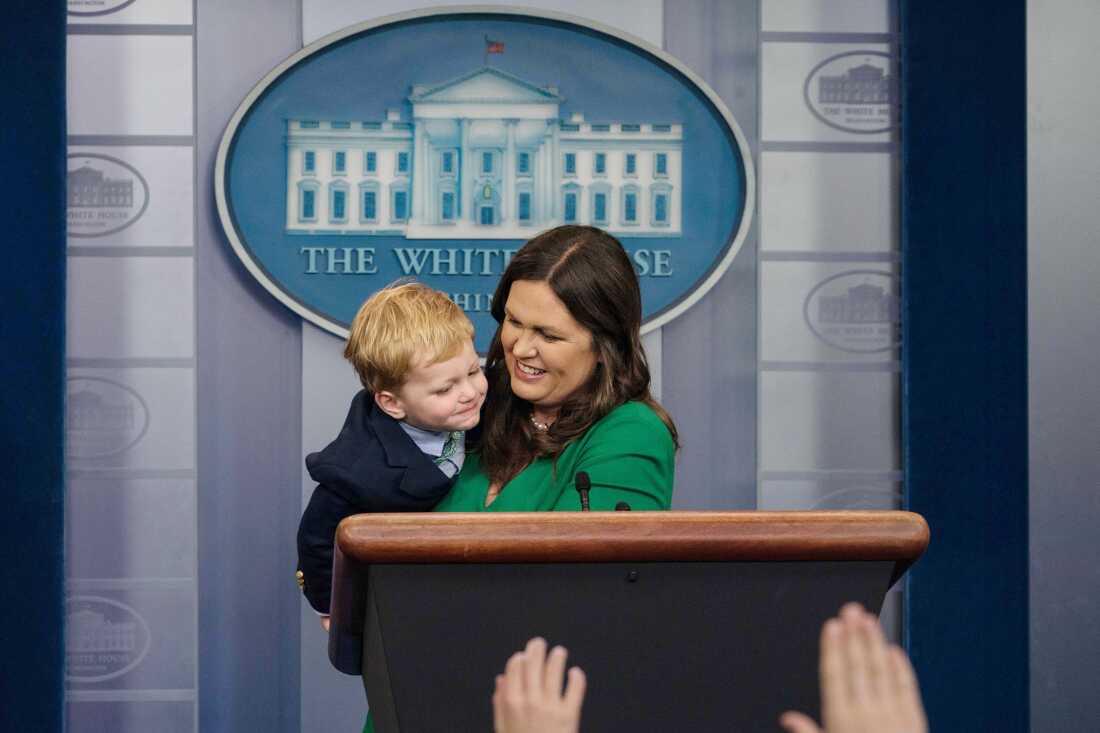 Sarah Huckabee Sanders plays with one of her sons in the locker room at 