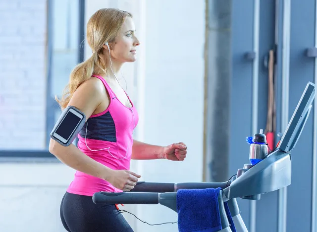 beautiful blonde woman doing treadmill incline walking workout